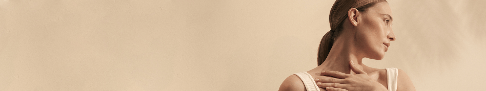 Kama model with her hand on her collar bone